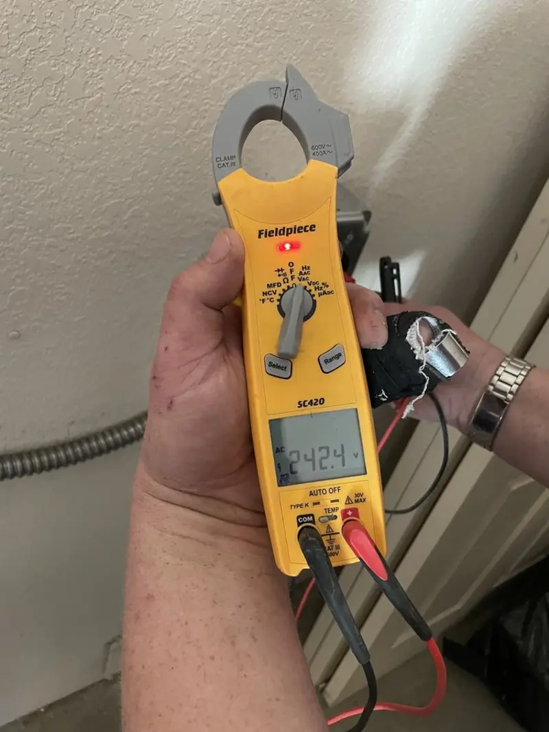 Voltage testing with clamp meter during Whole House Surge Protector in Hampton